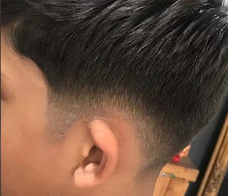 Close side view of a neatly blended fade haircut