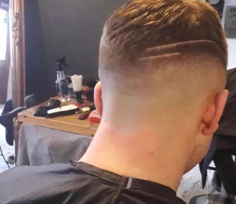 Back view of a short faded haircut with a clean neckline